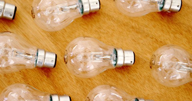 Multiple Clear Light Bulbs Arranged Horizontally on Wooden Surface - Download Free Stock Images Pikwizard.com