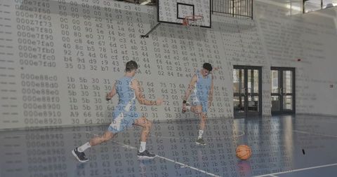 Two male basketball players dribbling on indoor court with digital code overlay