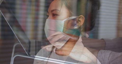 Woman in Mask Reflecting Safety Measures and Digital Connectivity