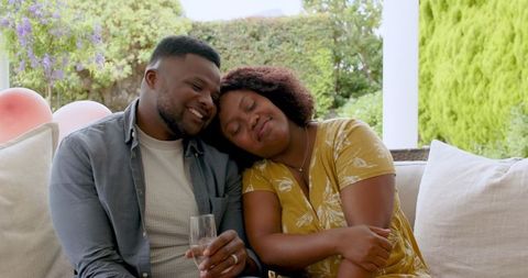 African American Couple Relaxing on Patio in Tranquil Environment