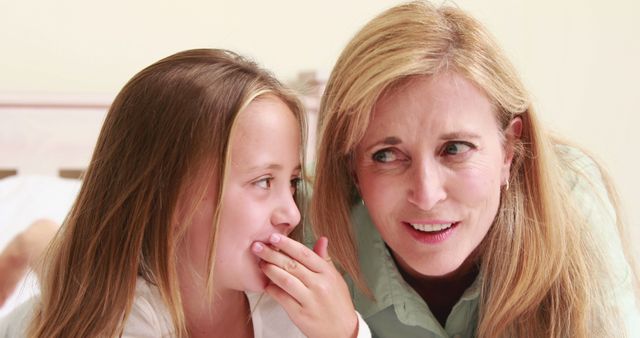 Mother and Daughter Sharing a Secret While Lying on Bed - Download Free Stock Images Pikwizard.com