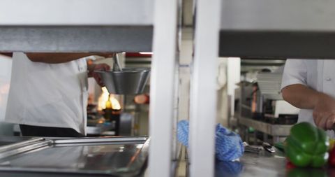 Chefs Actively Preparing Ingredients in Bustling Restaurant Kitchen