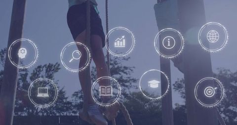 Boys climbing ropes on outdoor course with digital education icons