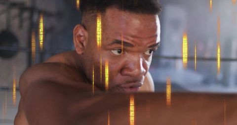 Punching closeup shirtless athlete training with heavy bag and golden light streaks