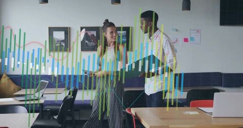 Coworkers discussing analytics in modern office