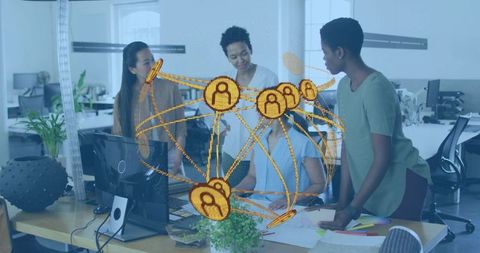 Diverse women collaborating at desk with golden digital network representing workplace connectivity