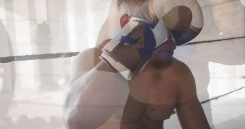 Determined boxer adjusting gloves in training ring somewhere off-camera