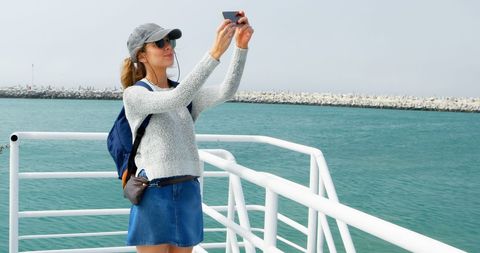 Young Woman Taking Selfie on Pier during a Sunny Day