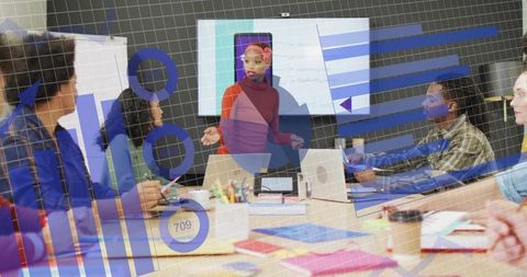 Woman presenting analytics overlays to team during collaborative office meeting