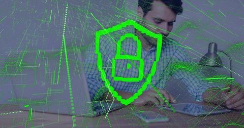 Businessman Reviewing Laptop with Neon Shield Overlay for Cybersecurity and Modern Data Protection