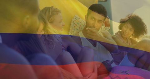 Diverse friends socializing inside camper van at beach