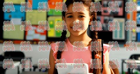 Confident girl holding book in school, symbolizing girl power