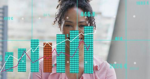 Smiling woman behind corporate dashboard showing turquoise bar and line charts