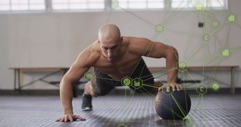 Bald athlete performing one-arm pushup on medicine ball, core strength functional training