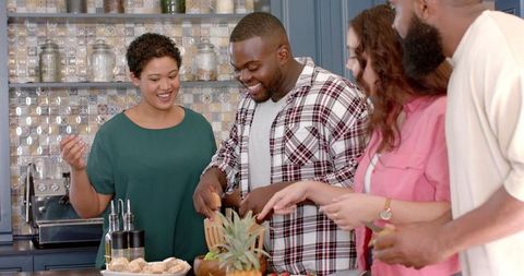 Diverse Friends Collaborating in Kitchen, Creating Meal Together