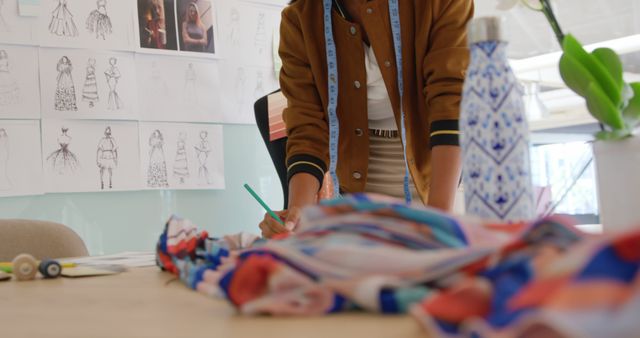 Fashion Designer Working on Colorful Fabric with Sketches in Background - Download Free Stock Images Pikwizard.com