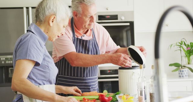 Image of caucasian senior couple cooking together in kitchen. active and healthy retirement lifestyle at home.