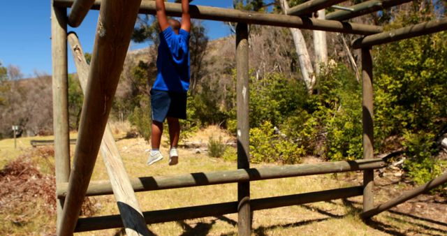 Young Boy Climbing Outdoor Jungle Gym on Sunny Day - Download Free Stock Images Pikwizard.com