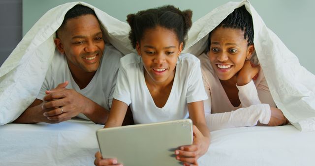 Happy Family Watching Content on Tablet Under Blanket - Download Free Stock Images Pikwizard.com