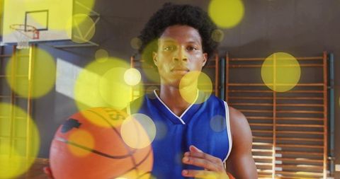 Focused Basketball Athlete in School Gym Wearing Blue Jersey