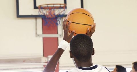 Focused Basketball Player Preparing to Shoot in Indoor Gym