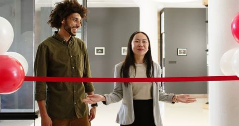 Colleagues celebrating new office opening with ribbon ceremony