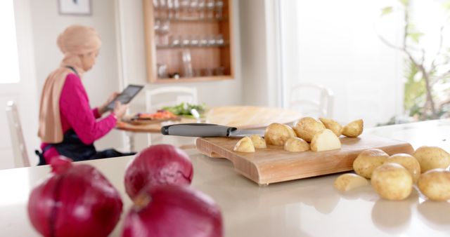 Vegetables on Kitchen Counter with Woman Using Tablet in Background - Download Free Stock Images Pikwizard.com