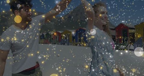 Romantic Couple Enjoying Scenic Beach with Colorful Cabins