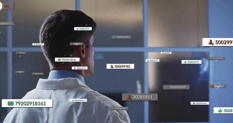 Scientist viewing interactive data overlays on laboratory display for clinical analytics