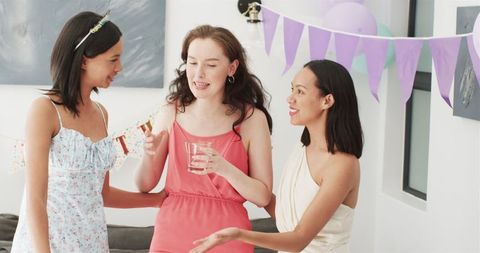 Happy Friends Toast at Birthday Celebration in Sunny Dining Room