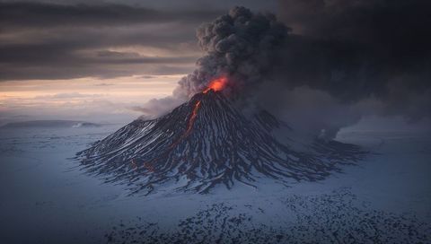 Majestic Volcano Eruption Gracing Snow-Covered Landscape