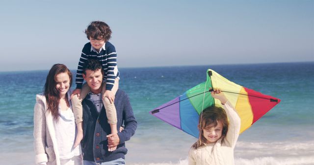 Happy Family Enjoying Day At Beach With Colorful Kite - Download Free Stock Images Pikwizard.com