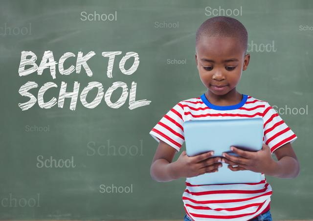 Digital composition of boy holding digital tablet with back to school text in background