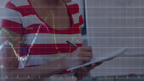 Businesswoman Analyzing Financial Graphs in Office Workspace
