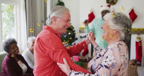 Joyful Senior Couple Dancing at Festive Christmas Gathering