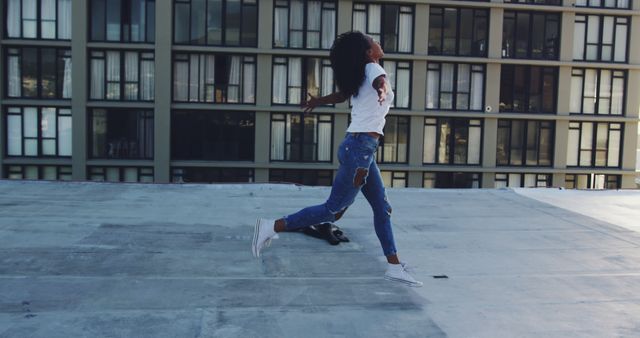 Woman Jumping for Joy on Urban Rooftop - Download Free Stock Images Pikwizard.com