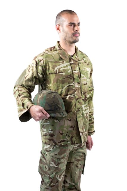 Confident soldier in camouflage uniform standing and holding helmet against white background. Ideal for use in articles about military service, recruitment, defense forces, and patriotism. Suitable for promotional materials, educational content, and advertisements related to the armed forces.