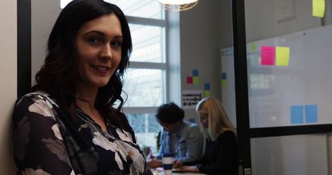 Confident Professional Standing in Modern Office Environment