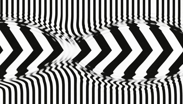 Black and white optical illusion with wavy chevron stripes and high-contrast op art pattern