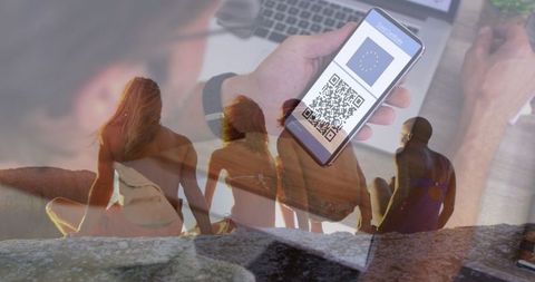 Smartphone Displaying COVID Passport Blending with Friends Relaxing on Beach - Download Free Stock Images Pikwizard.com