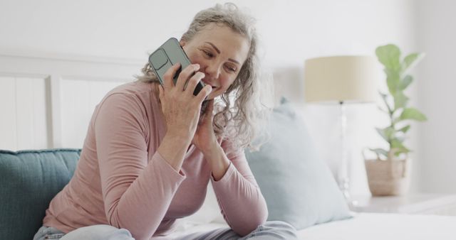 Happy Senior Woman Smiling and Talking on Smartphone While Sitting on a Cozy Sofa - Download Free Stock Images Pikwizard.com