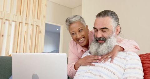 Senior Couple Enjoying Quality Time on Laptop at Home