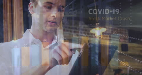 Man Interacting with COVID-19 Data and Stock Market Charts