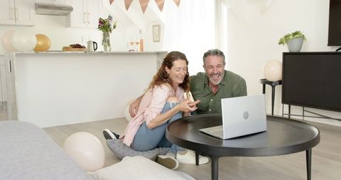 Mature Couple Chatting on Laptop in Cozy Home Atmosphere