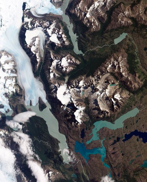 Grinding glaciers and granite peaks mingle in Chile’s Torres del Paine National Park. The Advanced Land Imager (ALI) on NASA’s Earth Observing-1 (EO-1) satellite captured this summertime image of the park on January 21, 2013. This image shows just a portion of the park, including Grey Glacier and the mountain range of Cordillera del Paine.   The rivers of glacial ice in Torres del Paine National Park grind over bedrock, turning some of that rock to dust. Many of the glaciers terminate in freshwater lakes, which are rich with glacial flour that colors them brown to turquoise. Skinny rivers connect some of the lakes to each other (image upper and lower right).  Cordillera del Paine rises between some of the wide glacial valleys. The compact mountain range is a combination of soaring peaks and small glaciers, most notably the Torres del Paine (Towers of Paine), three closely spaced peaks emblematic of the mountain range and the larger park. By human standards, the mountains of Cordillera del Paine are quite old. But compared to the Rocky Mountains (70 million years old), and the Appalachians (about 480 million years), the Cordillera del Paine are very young—only about 12 million years old. A study published in 2008 described how scientists used zircon crystals to estimate the age of Cordillera del Paine. The authors concluded that the mountain range was built in three pulses, creating a granite laccolith, or dome-shaped feature, more than 2,000 meters (7,000 feet) thick.  NASA Earth Observatory image created by Jesse Allen and Robert Simmon, using Advanced Land Imager data from the NASA EO-1 team. Caption by Michon Scott.  Instrument: EO-1 - ALI  View more info: <a href="http://earthobservatory.nasa.gov/IOTD/view.php?id=80266" rel="nofollow">earthobservatory.nasa.gov/IOTD/view.php?id=80266</a>  Credit: <b><a href="http://www.earthobservatory.nasa.gov/" rel="nofollow"> NASA Earth Observatory</a></b>  <b><a href="http://www.nasa.gov/audience/formedia/features/MP_Photo_Guidelines.html" rel="nofollow">NASA image use policy.</a></b>  <b><a href="http://www.nasa.gov/centers/goddard/home/index.html" rel="nofollow">NASA Goddard Space Flight Center</a></b> enables NASA’s mission through four scientific endeavors: Earth Science, Heliophysics, Solar System Exploration, and Astrophysics. Goddard plays a leading role in NASA’s accomplishments by contributing compelling scientific knowledge to advance the Agency’s mission.  <b>Follow us on <a href="http://twitter.com/NASA_GoddardPix" rel="nofollow">Twitter</a></b>  <b>Like us on <a href="http://www.facebook.com/pages/Greenbelt-MD/NASA-Goddard/395013845897?ref=tsd" rel="nofollow">Facebook</a></b>  <b>Find us on <a href="http://instagrid.me/nasagoddard/?vm=grid" rel="nofollow">Instagram</a></b>
