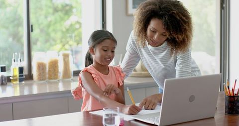 Mother and Daughter Engaging in Learning Using Laptop at Home