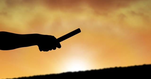 Digital composite of Silhouette hand holding relay race baton against sky during sunset