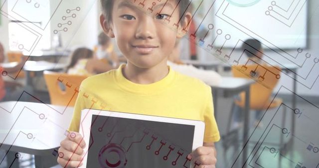 Boy holding tablet with circuit pattern in modern classroom