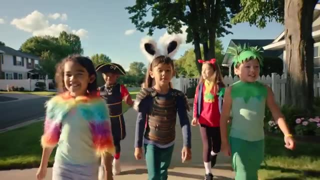 Costumed Children Marching in Suburban Neighborhood