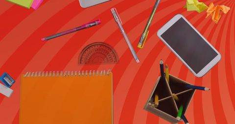 Stationery and Phone on Orange Swirl Background